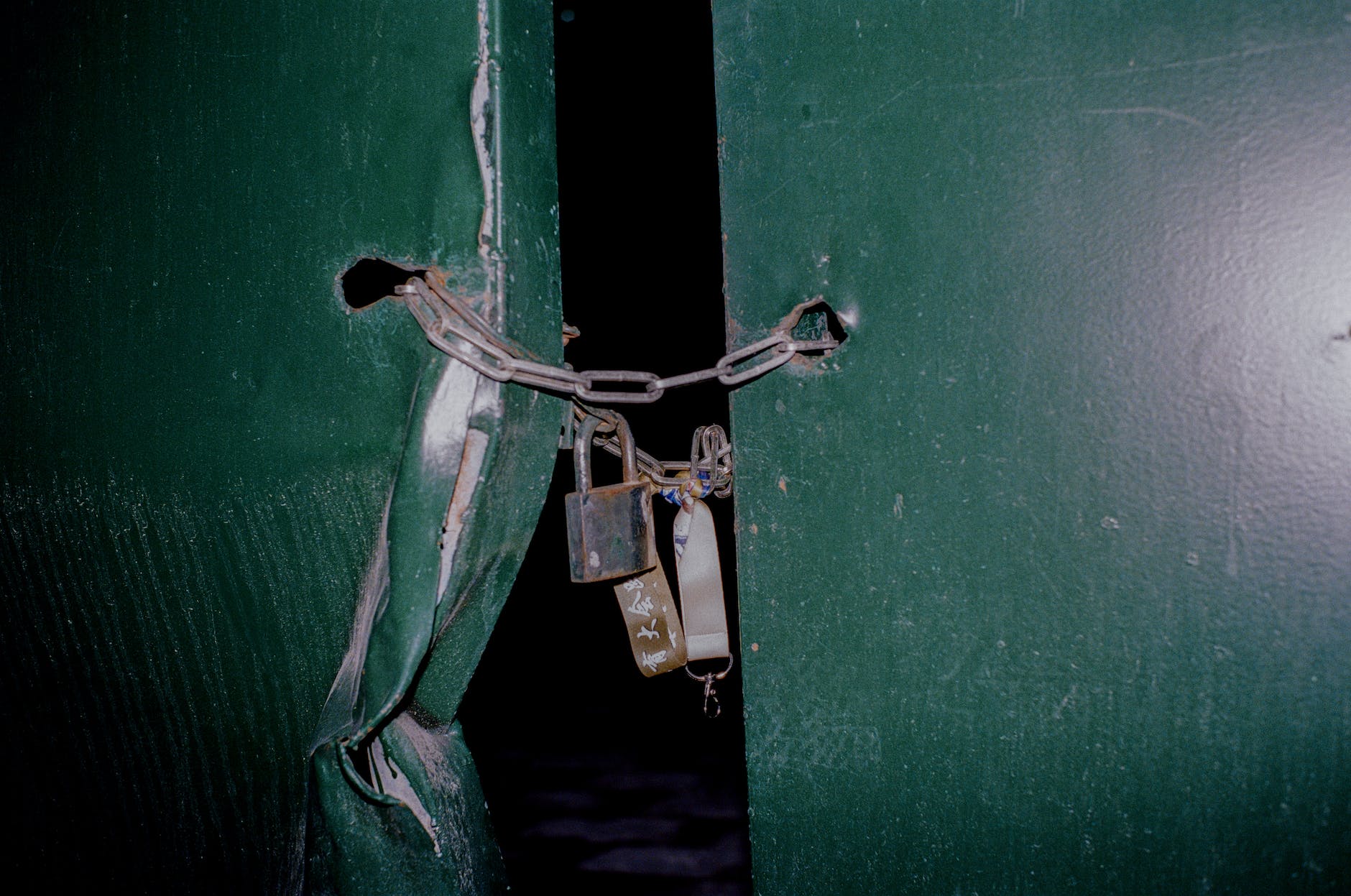 padlock on chain closing the metal door